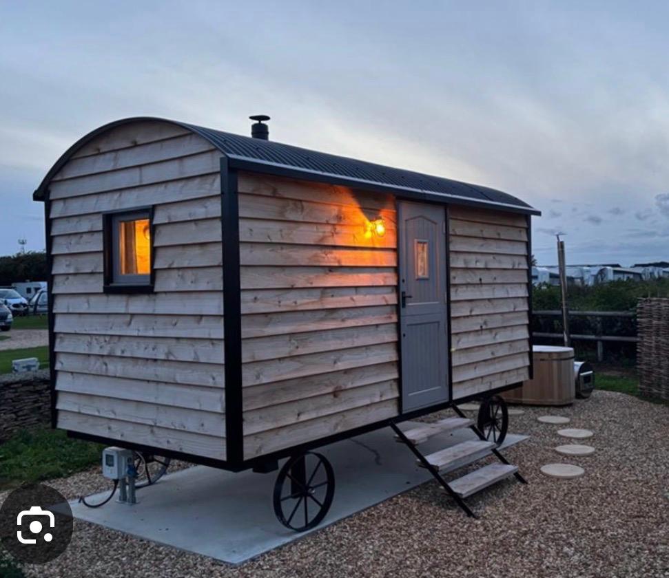 Shepherd hut lit at dusk