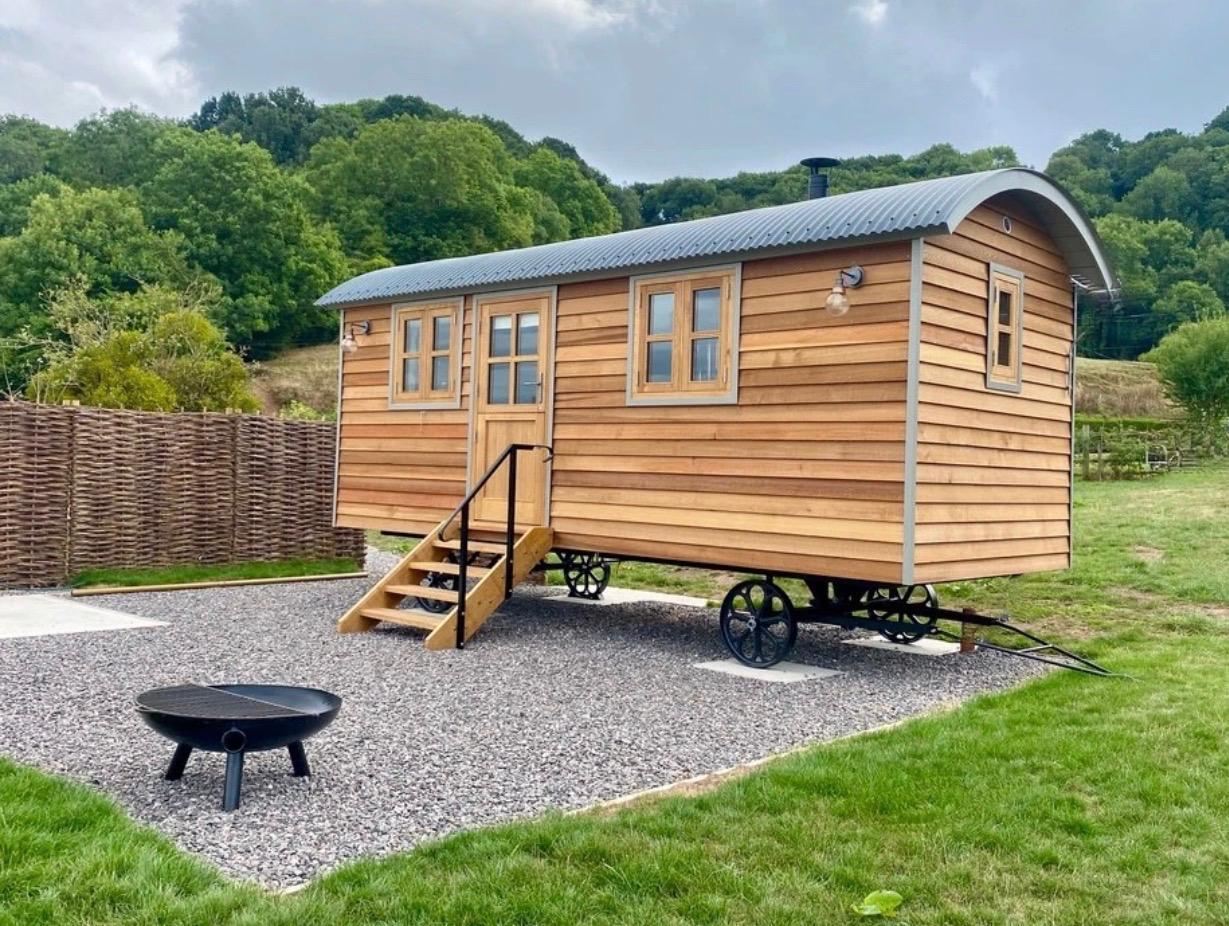 A finished shepherd hut in a countryside setting