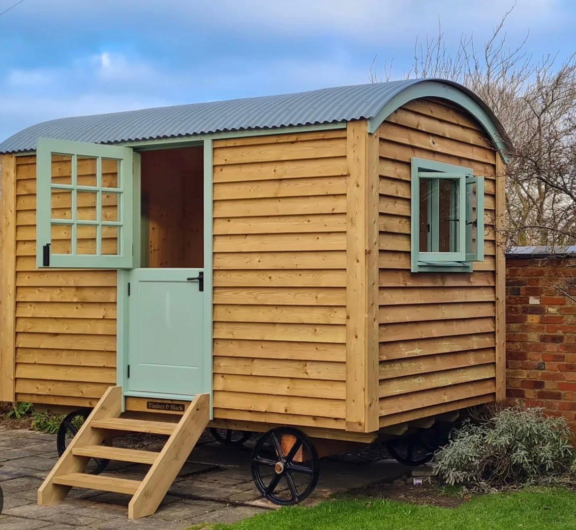 Bespoke shepherd hut with a sage-green stable door