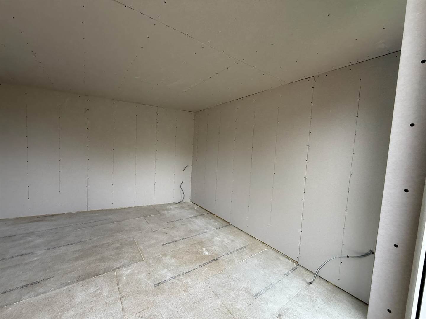 The garden room interior insulated, first-fixed and plasterboarded