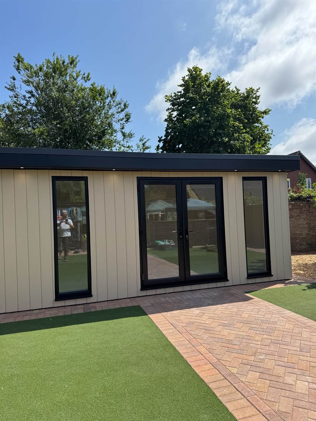 Anthracite French doors flanked by full-height windows